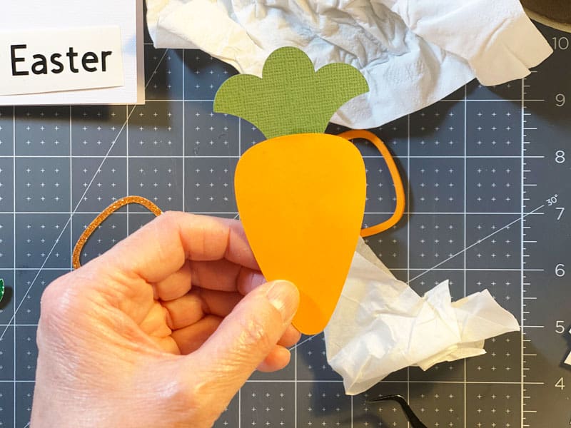 The green leaf piece glued to the solid carrot piece.
