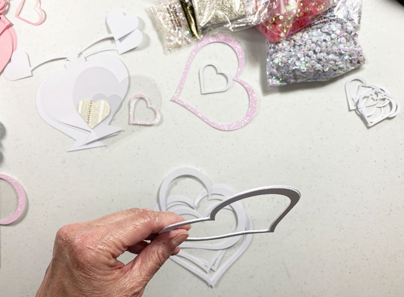 I glued the five large heart outline pieces together.