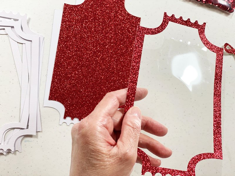 Acetate glue onto red glitter cardstock border.